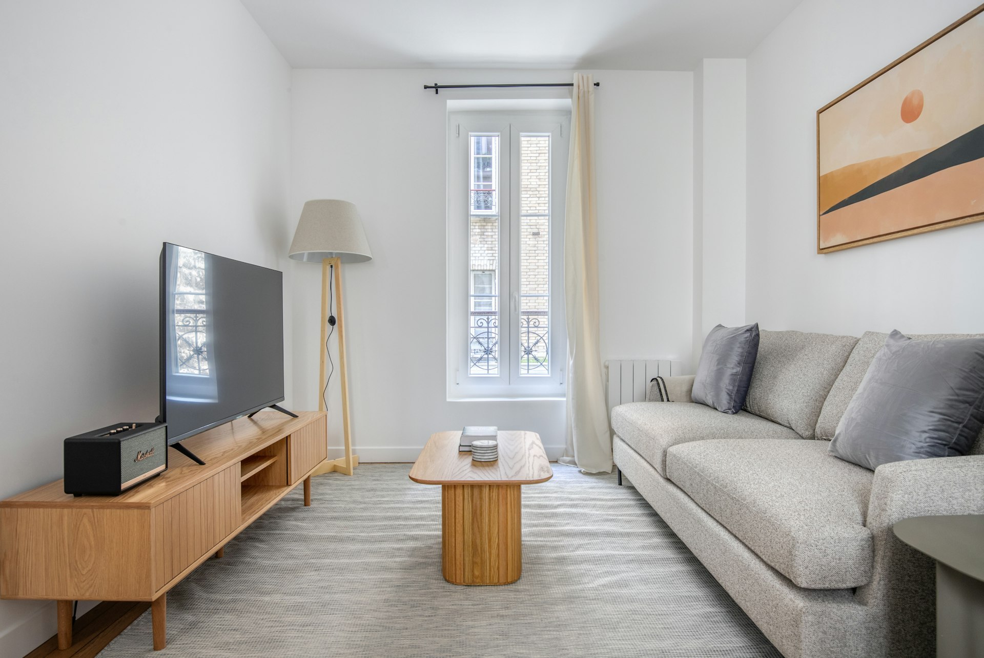 a living room filled with furniture and a flat screen tv